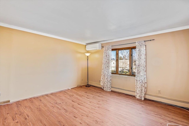 spare room featuring a wall mounted air conditioner, ornamental molding, and light hardwood / wood-style flooring