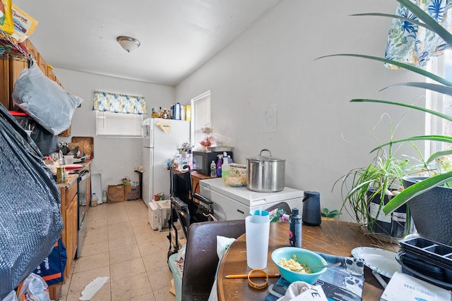 interior space with white fridge and light tile patterned floors