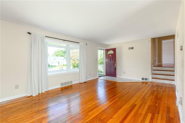 empty room with light hardwood / wood-style flooring