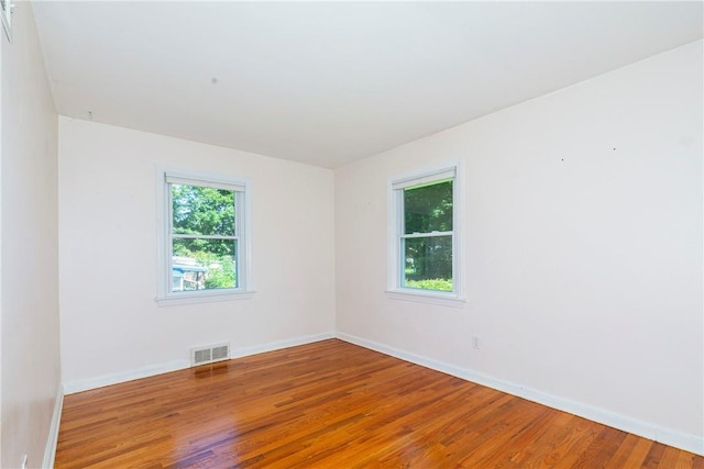 spare room with hardwood / wood-style flooring