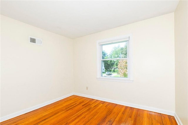 unfurnished room with hardwood / wood-style floors