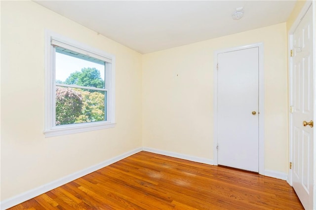 empty room with light hardwood / wood-style flooring