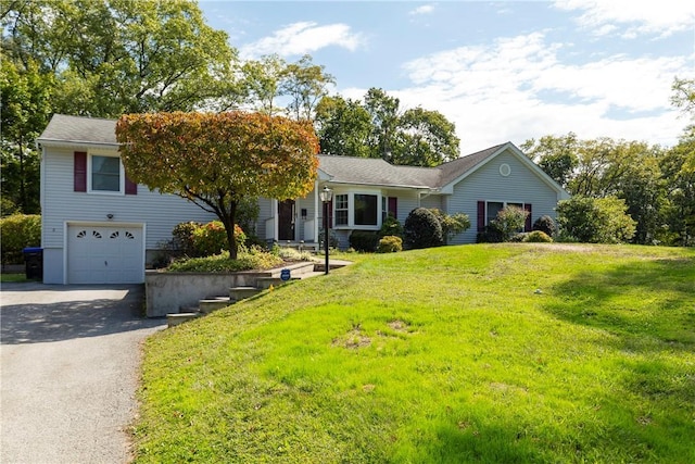 view of front of property with a front yard and a garage