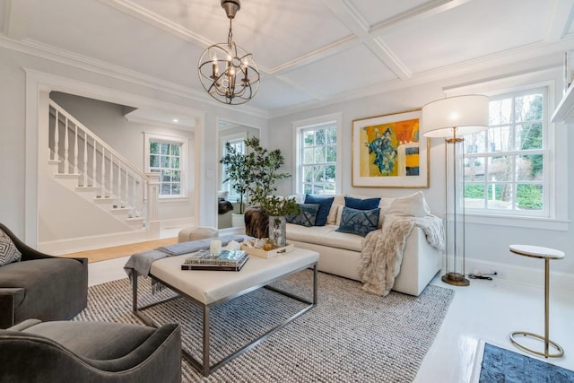 living room featuring a chandelier, hardwood / wood-style floors, a healthy amount of sunlight, and coffered ceiling