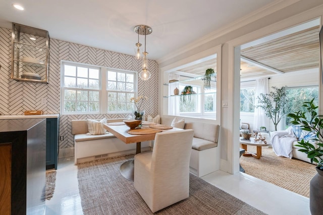 dining area featuring breakfast area, a wealth of natural light, crown molding, and light tile patterned flooring