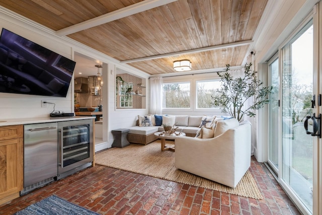 living room featuring indoor bar, beverage cooler, and wood ceiling