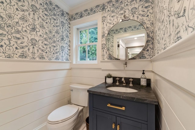 bathroom featuring vanity, toilet, and crown molding