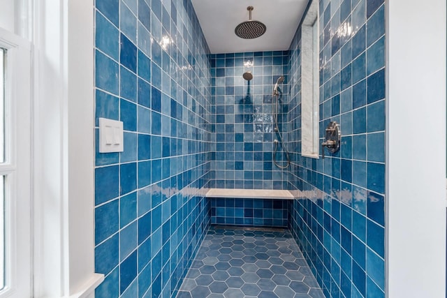 bathroom with tile patterned floors, tiled shower, and tile walls