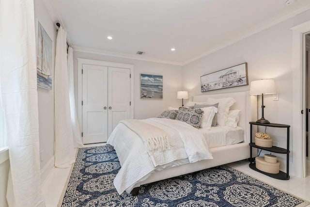 tiled bedroom with crown molding and a closet