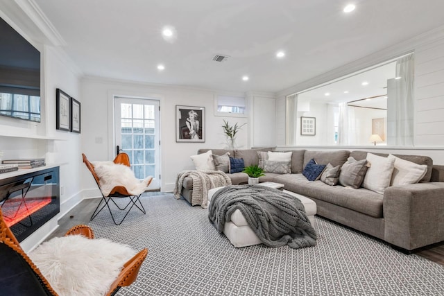 living room featuring crown molding and wood-type flooring