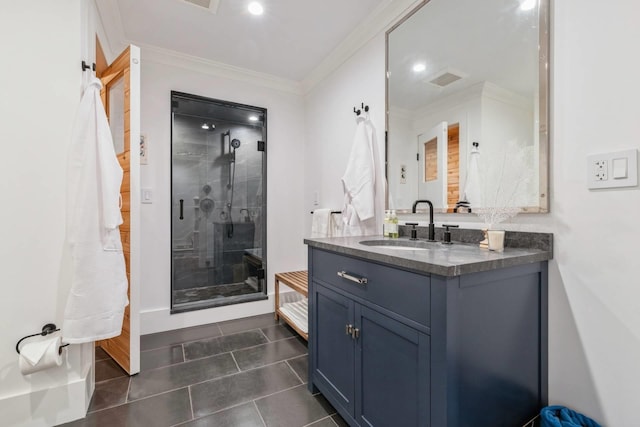 bathroom with tile patterned flooring, vanity, a shower with shower door, and ornamental molding