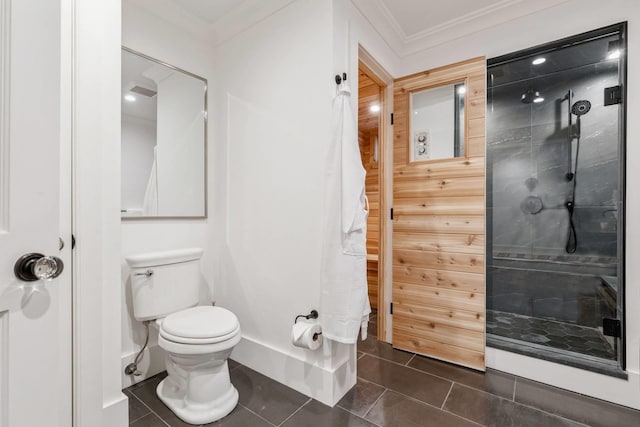 bathroom featuring toilet, a shower, tile patterned floors, and crown molding