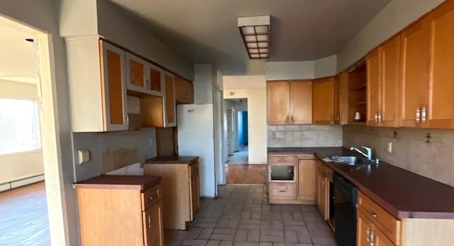 kitchen featuring backsplash, a baseboard heating unit, sink, white refrigerator, and dishwasher