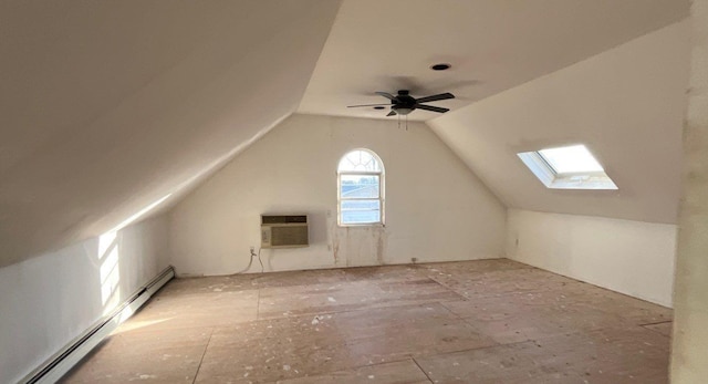 additional living space featuring a wall mounted AC, lofted ceiling with skylight, ceiling fan, and a baseboard radiator