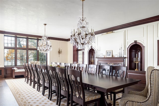 dining space with light hardwood / wood-style flooring and ornamental molding