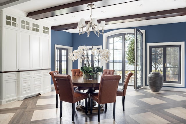 dining space with beamed ceiling, french doors, and an inviting chandelier