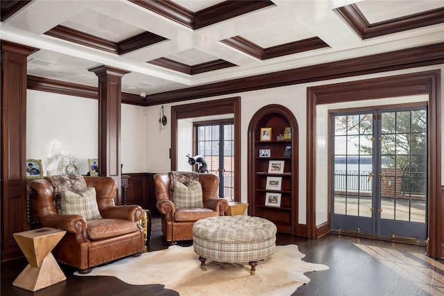 living area featuring plenty of natural light, ornate columns, ornamental molding, and french doors