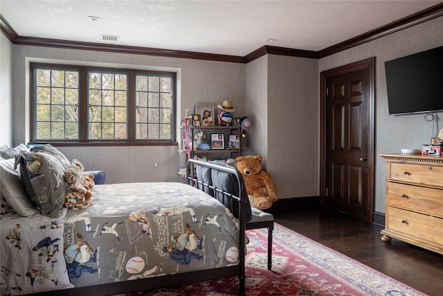 bedroom with dark hardwood / wood-style flooring and ornamental molding