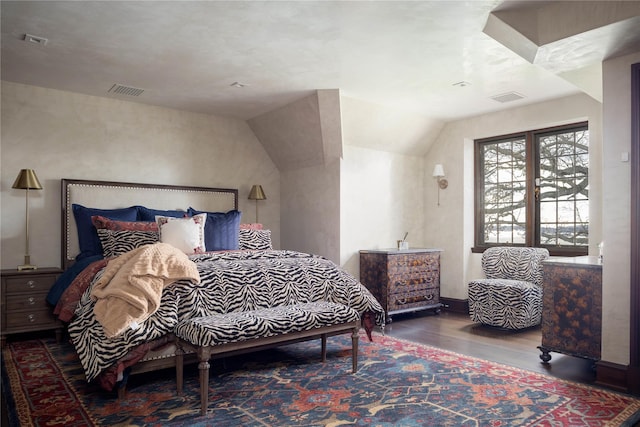 bedroom with hardwood / wood-style floors and lofted ceiling