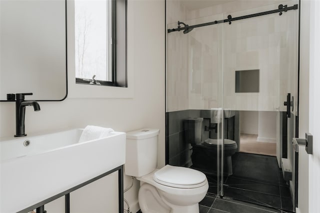 bathroom with tile patterned floors, toilet, vanity, and tiled shower