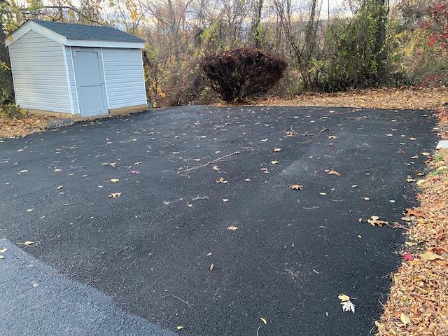 exterior space with a storage shed