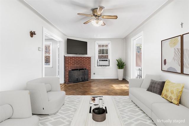 living room with ceiling fan, cooling unit, parquet floors, and a brick fireplace