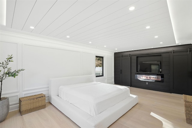 bedroom featuring wooden ceiling and light hardwood / wood-style floors