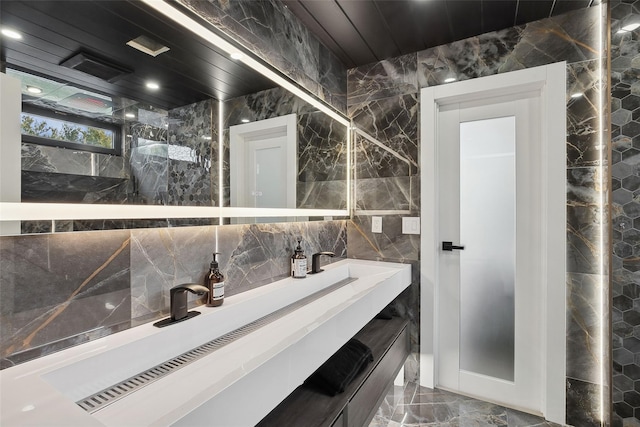 bathroom featuring tile walls and vanity