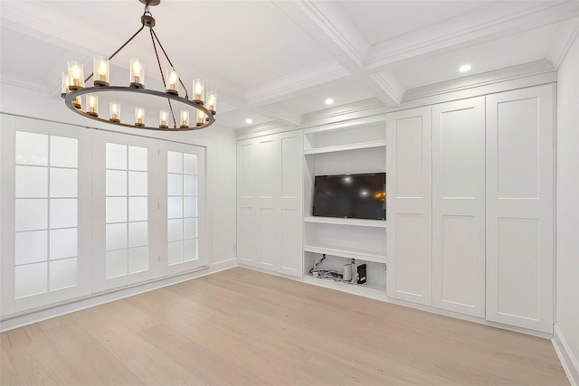 unfurnished living room with a notable chandelier, beamed ceiling, coffered ceiling, light wood-type flooring, and built in shelves