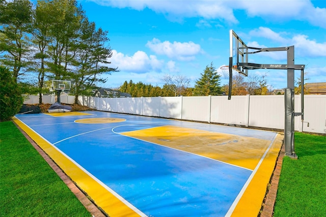 view of basketball court with a lawn