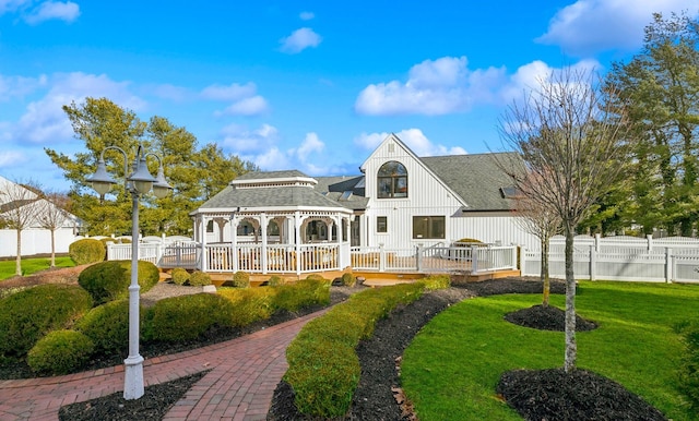 back of property with a gazebo and a yard