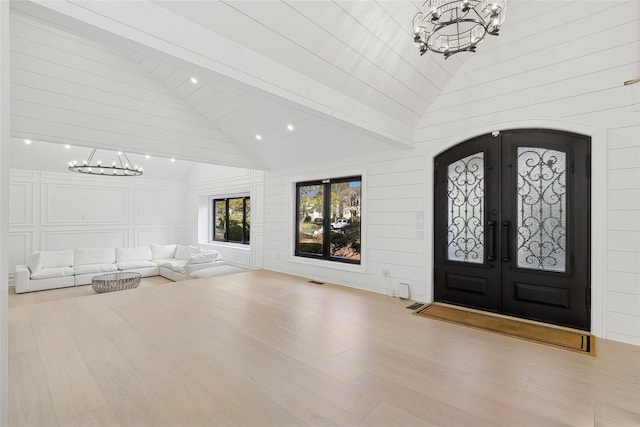 entrance foyer with light hardwood / wood-style flooring, french doors, and high vaulted ceiling