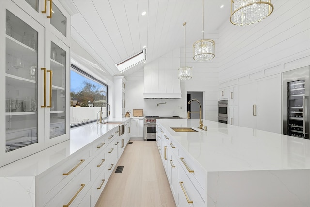 kitchen featuring high vaulted ceiling, sink, pendant lighting, and a spacious island