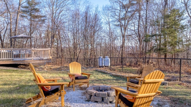 view of yard featuring a wooden deck and an outdoor fire pit