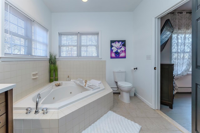 bathroom with tile patterned floors, tiled bath, toilet, and a baseboard radiator