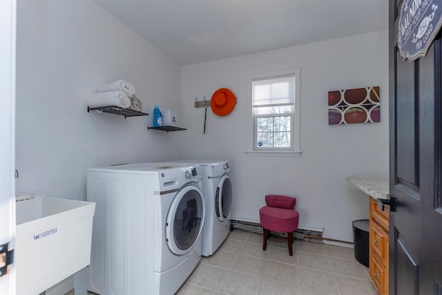 laundry area with independent washer and dryer, light tile patterned floors, and sink