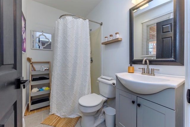 bathroom with tile patterned flooring, vanity, and toilet