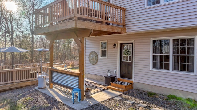 view of exterior entry featuring a wooden deck