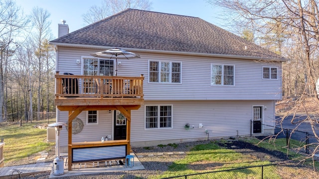 back of house with a deck and a yard