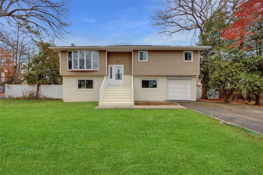 view of front of property featuring a garage and a front lawn