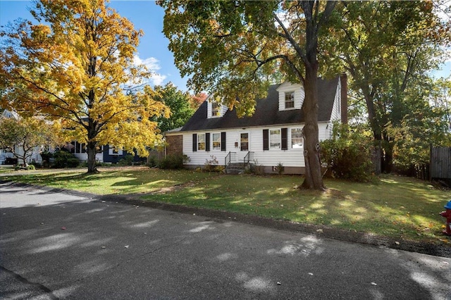 new england style home with a front yard