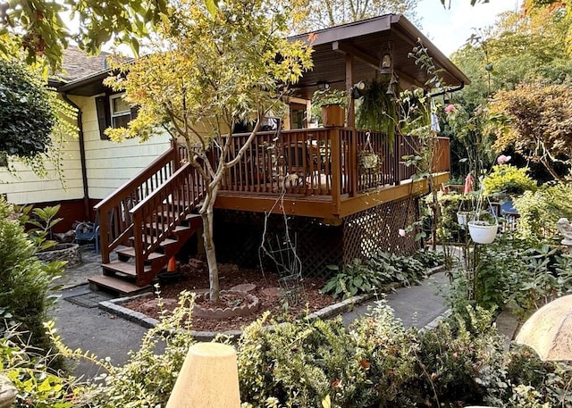 rear view of house with a wooden deck