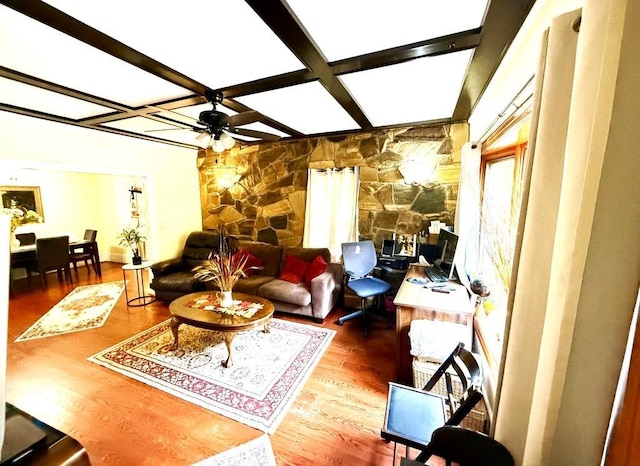 living room featuring ceiling fan, hardwood / wood-style floors, beamed ceiling, and coffered ceiling