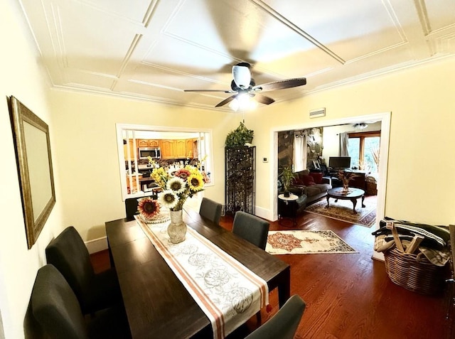 dining area with ceiling fan, dark hardwood / wood-style flooring, and coffered ceiling