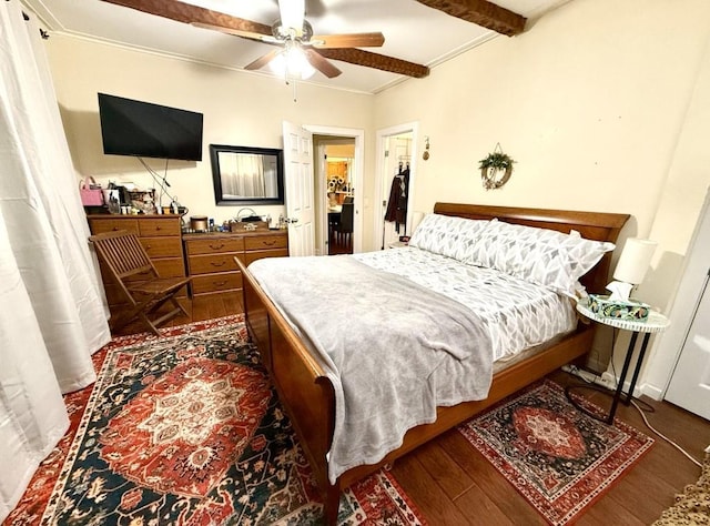 bedroom with ceiling fan, beam ceiling, crown molding, and dark wood-type flooring