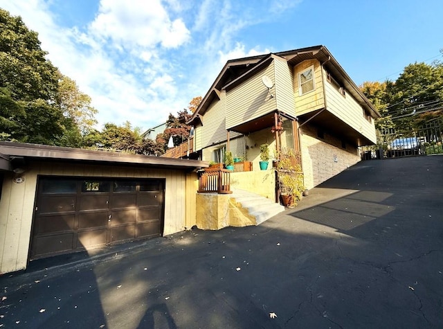 view of side of home featuring a garage