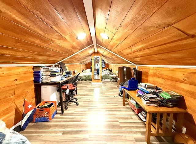 interior space featuring hardwood / wood-style flooring, lofted ceiling, wood walls, and wooden ceiling