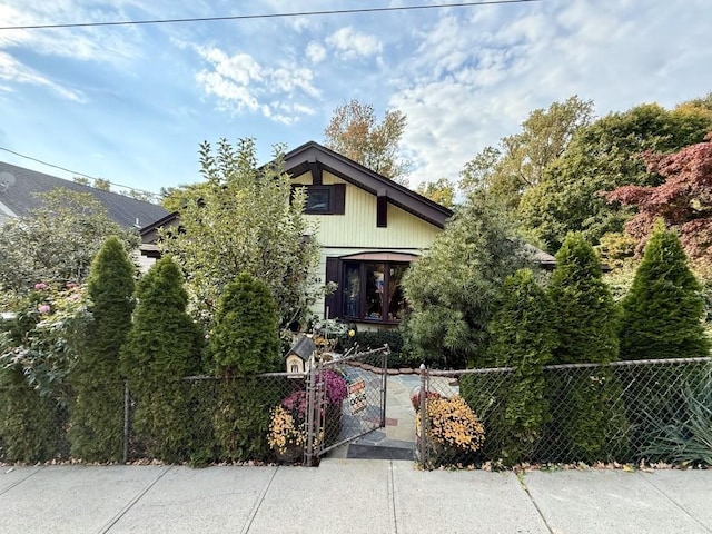 obstructed view of property with a gate and a fenced front yard