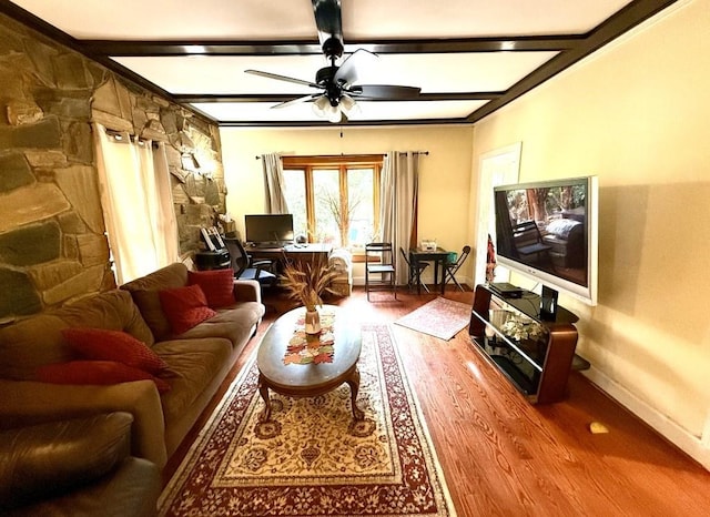 living room featuring baseboards, ceiling fan, wood finished floors, and beamed ceiling