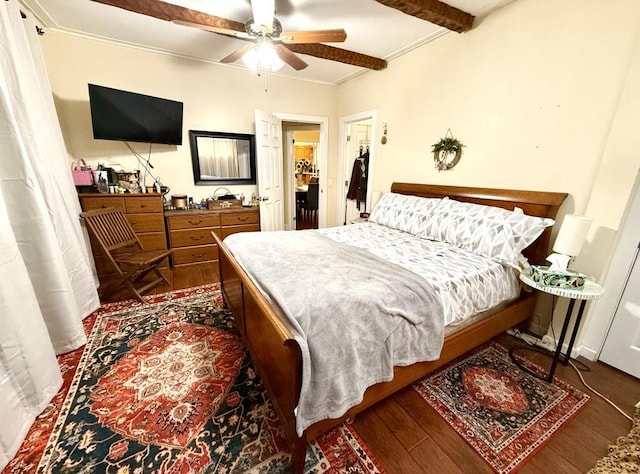 bedroom featuring a ceiling fan, ornamental molding, and wood finished floors